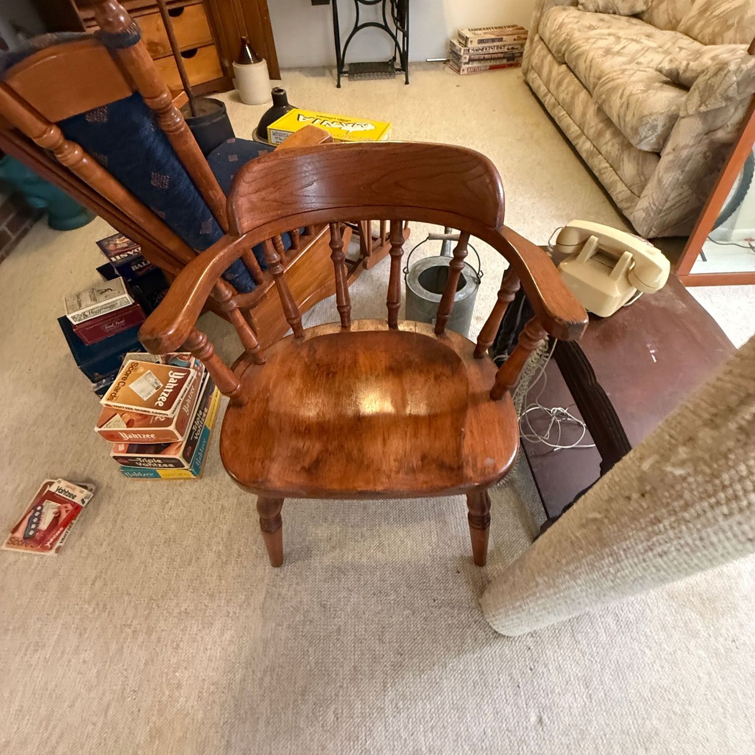 Wooden armchair with spindle back, some wear, has a repaired crack on seat Wooden armchair with spindle back, some wear, has a repaired crack on seat