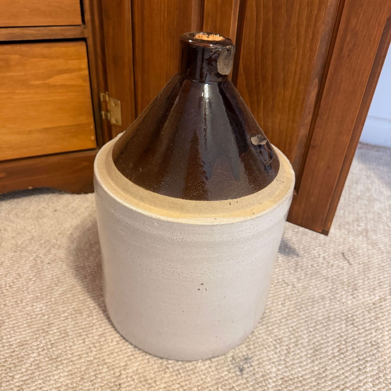 Brown and white 2-gallon jug, missing handle