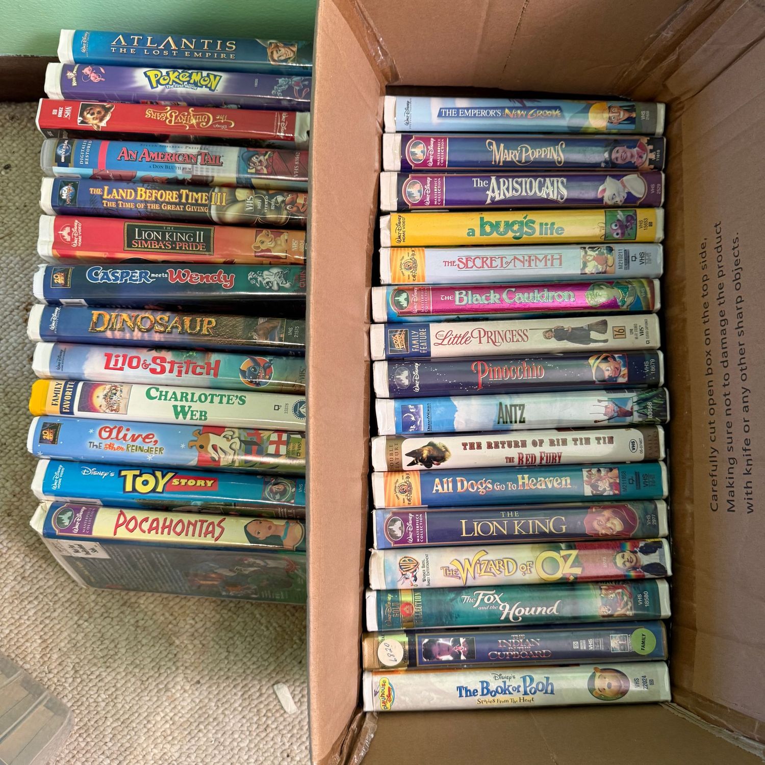 Cardboard box with vintage VHS tapes (includes all tapes seen in photos)