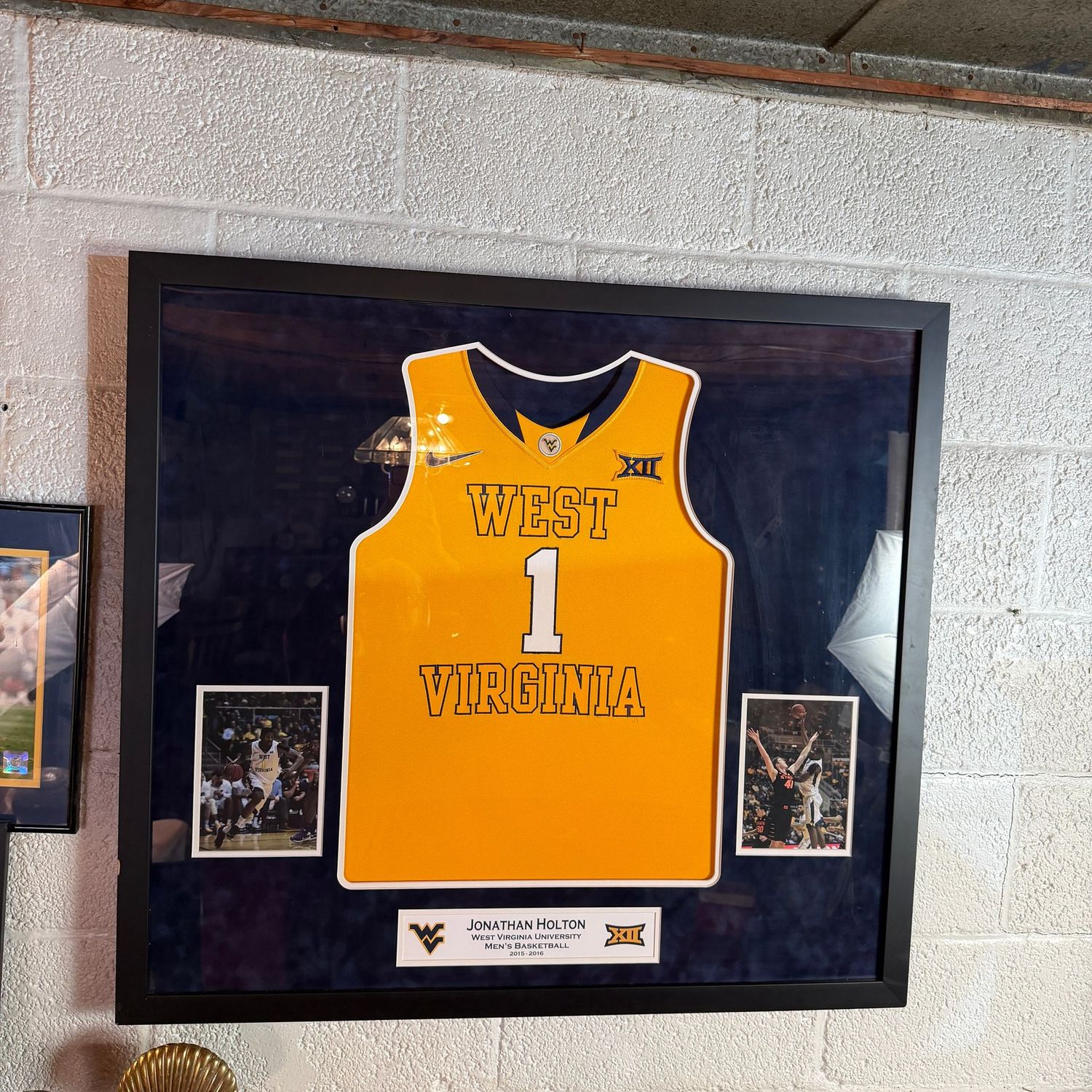 Jonathan Holton WVU Basketball framed jersey and photographs, nicely framed (minor nick on one side), wood frame with plexiglass, 33" x 36"
