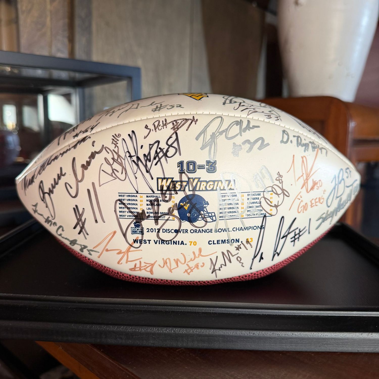 Football in case #5 Orange Bowl with multiple autographs including Bruce Irvin, Ryan Clarke, Keith Tandy, and more