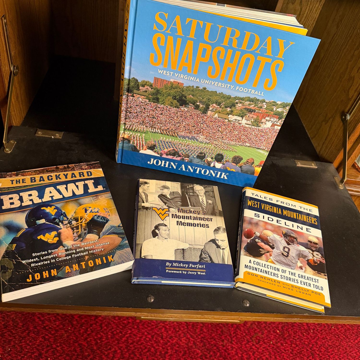 Group of West Virginia University books including Saturday Snapshots, Backyard Brawl, Mikey's Mountaineer Memories and Tales from the Sideline, nice condition