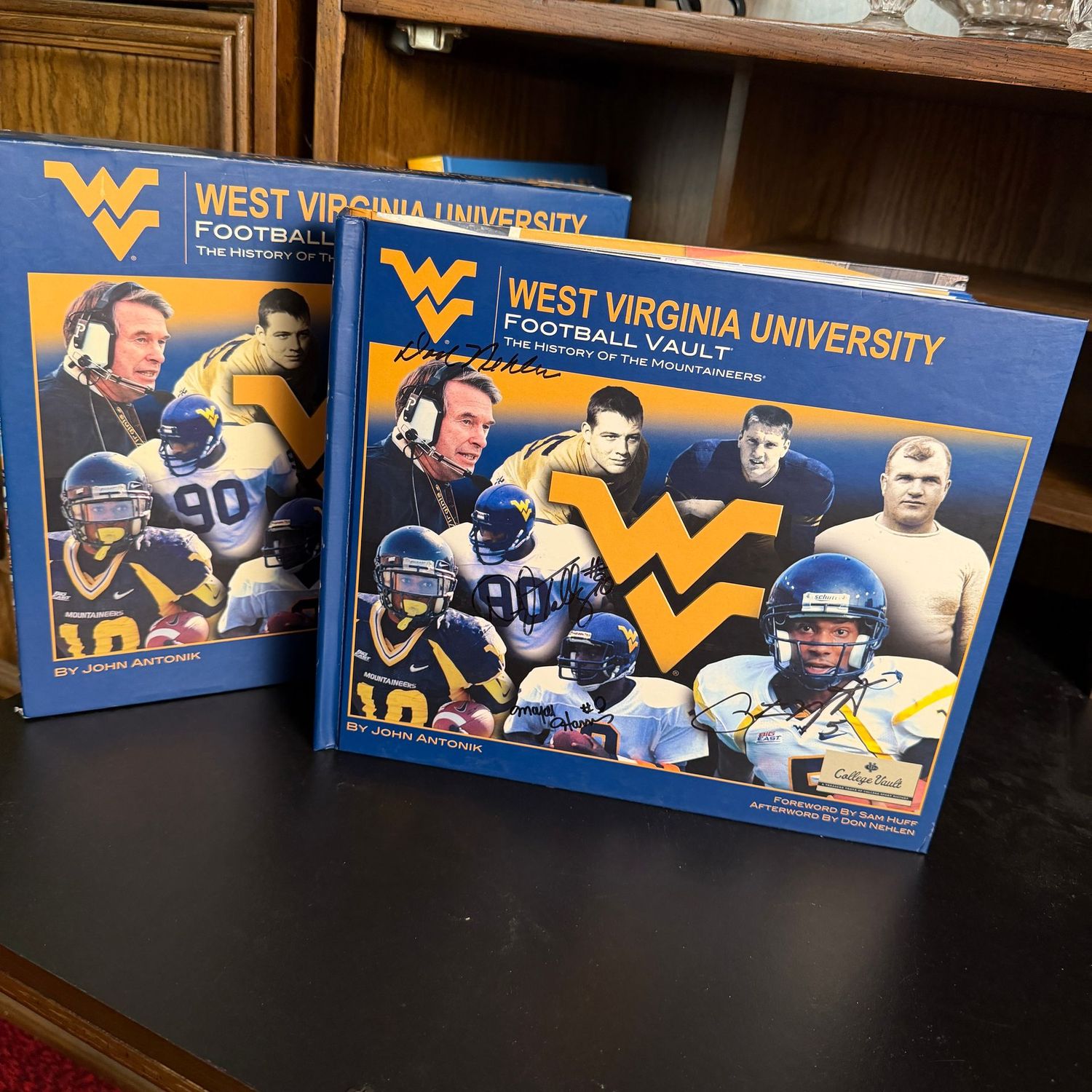 Signed West Virginia University Football Vault History of the Mountaineers book with sleeve, signed by Don Nehlen, Darryl Talley, Major Harris and Pat White