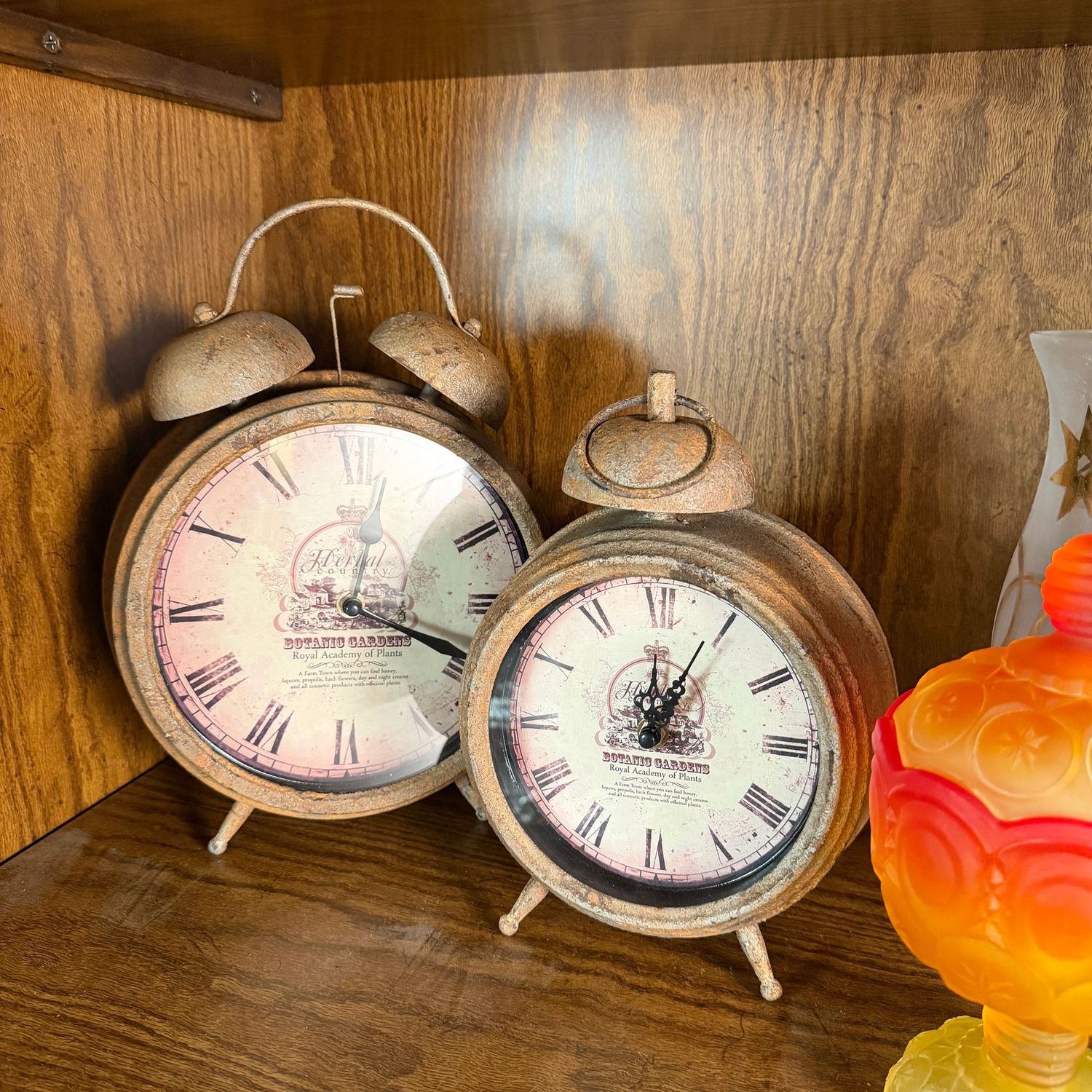 Two battery-operated clocks with vintage patina, alarm clock shape, the tallest is 12"H