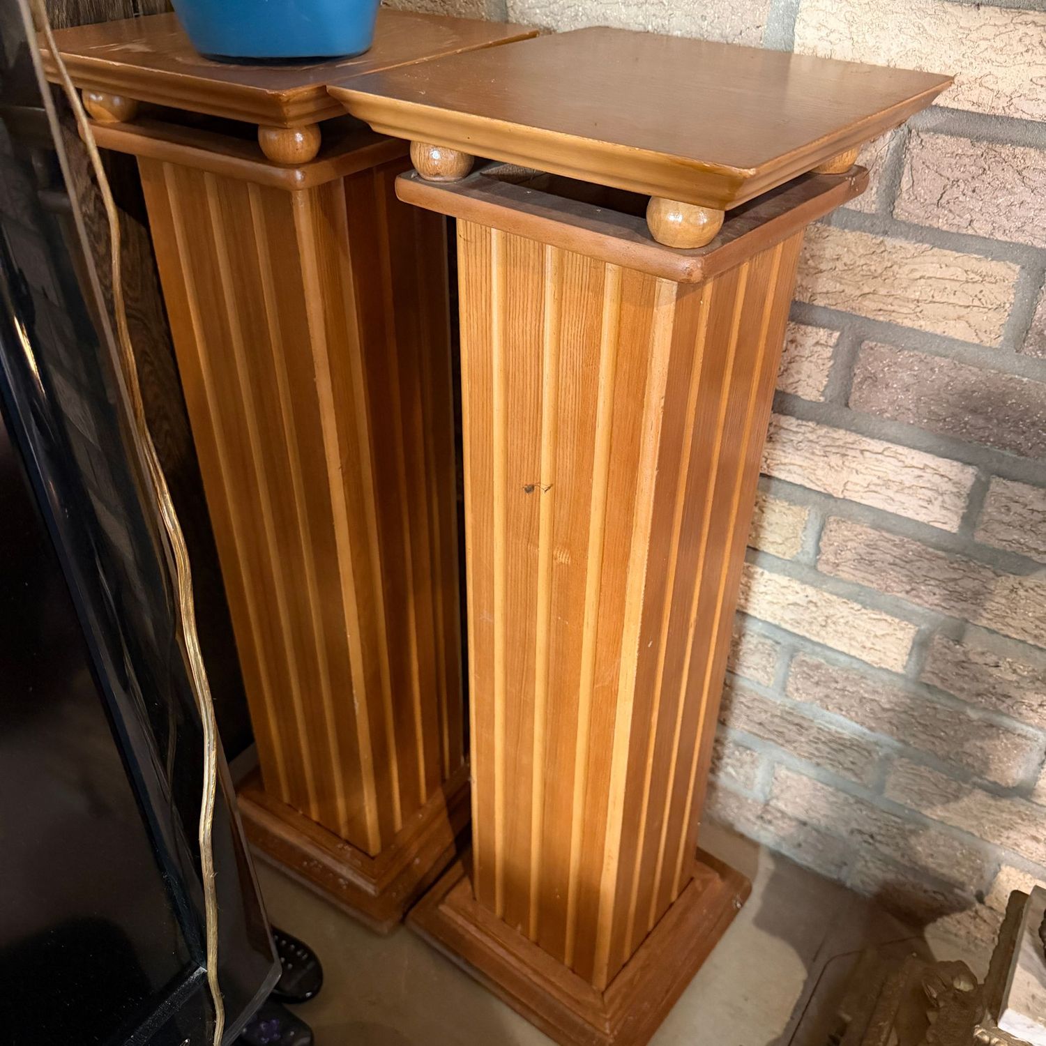 Pair of wooden pillar pedestal stands, one has some discoloration to the top, both have some minor scratches and wear, 30"H x 10"W (This item is heavy & in the lower level)