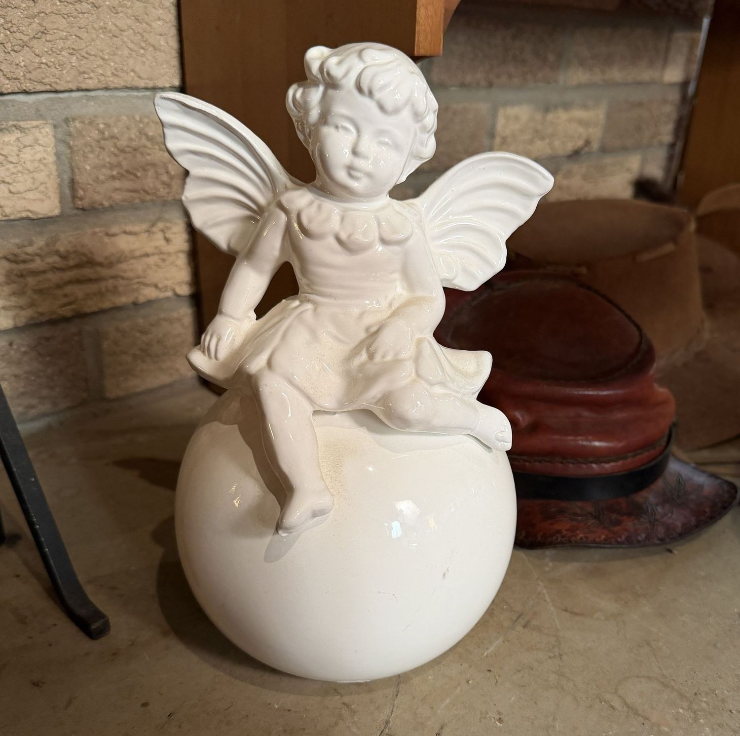 White ceramic cherub on ball, 10"H