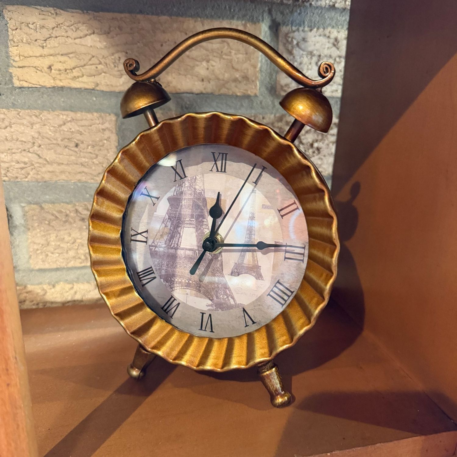 Battery-operated clock with Eiffel Tower background, scalloped border and alarm clock shape, 8"H