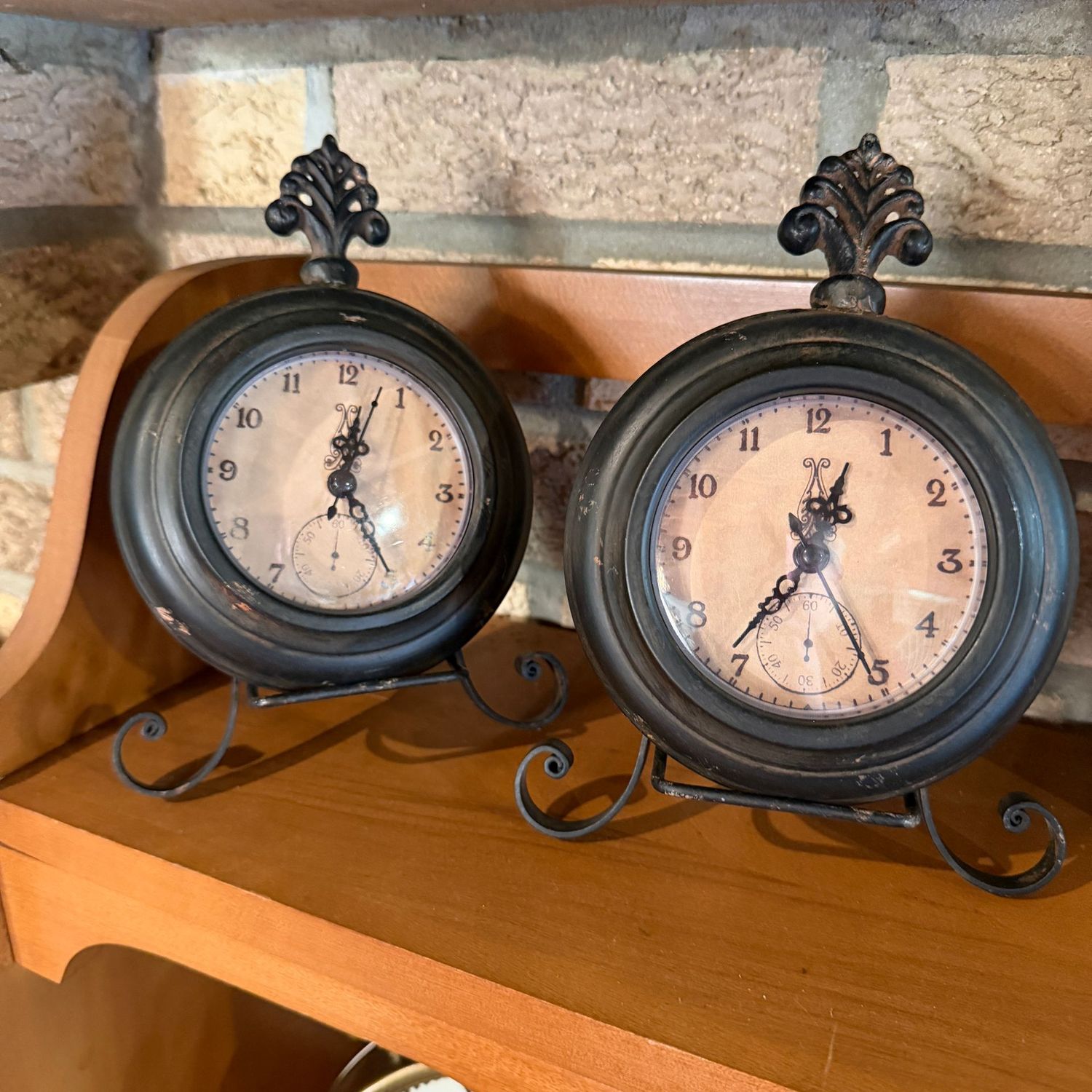 Pair of battery-operated clocks with scrolled finial on separate base, 8"H