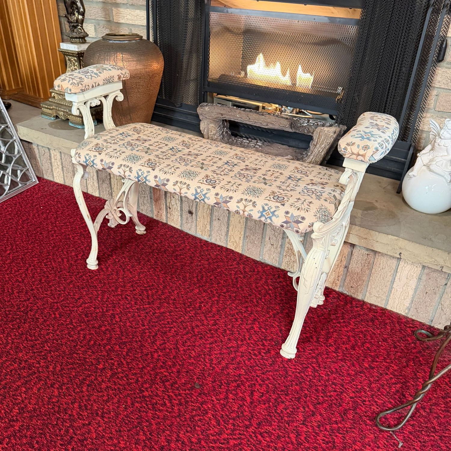 Painted cast iron bench with badded seat and arms, 23"H x 10"D x 33"L (This item is heavy & in the lower level)