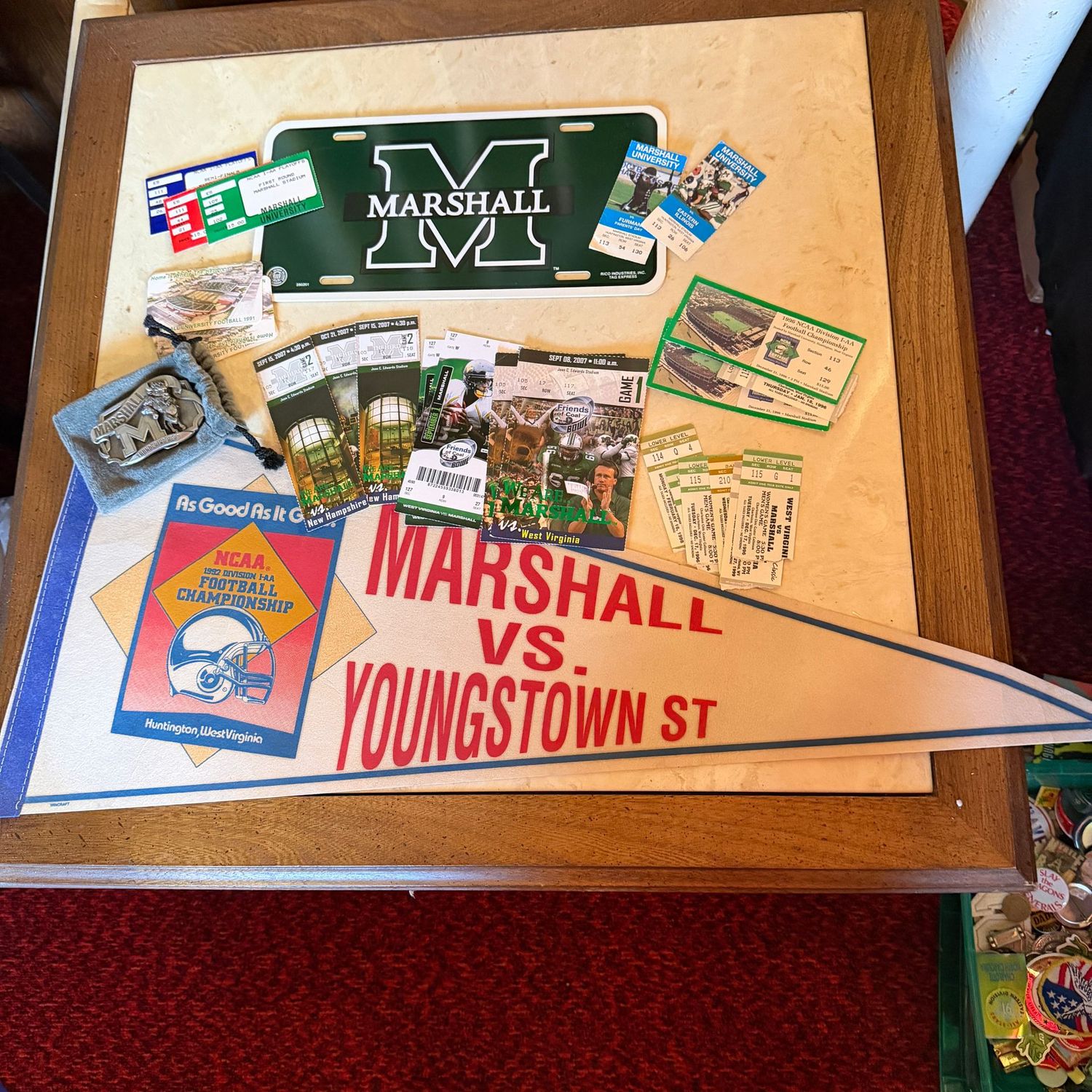 Sports Memorabilia Lot B with Marshall pennant, game tickets, belt buckle, and plastic license plate