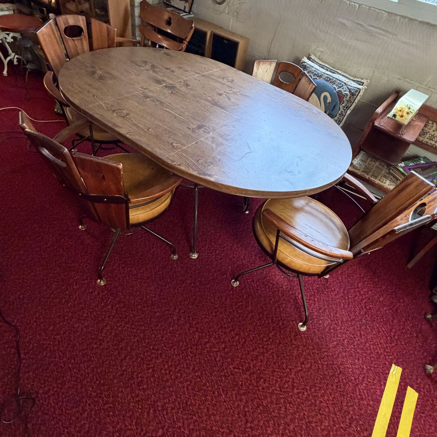 Vintage Blacksmith Shop oval/round dining table 5'L, 42"W, 17" leaf, 4 wooden swivel chairs with yellow vinyl seats, iron  legs, table has minor wear, chairs show some scratches (Heavy, Lower Level)