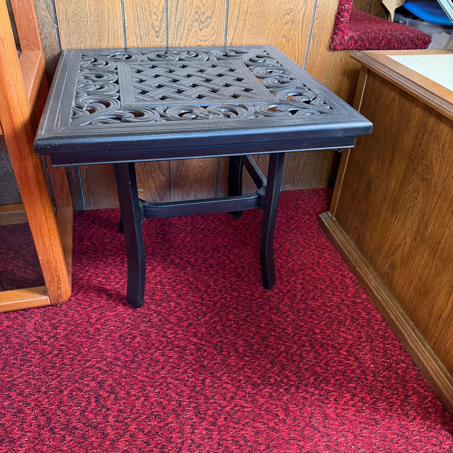 Black patio side table with cast metal top and tubular base, nice condition, 18"H x 21"W