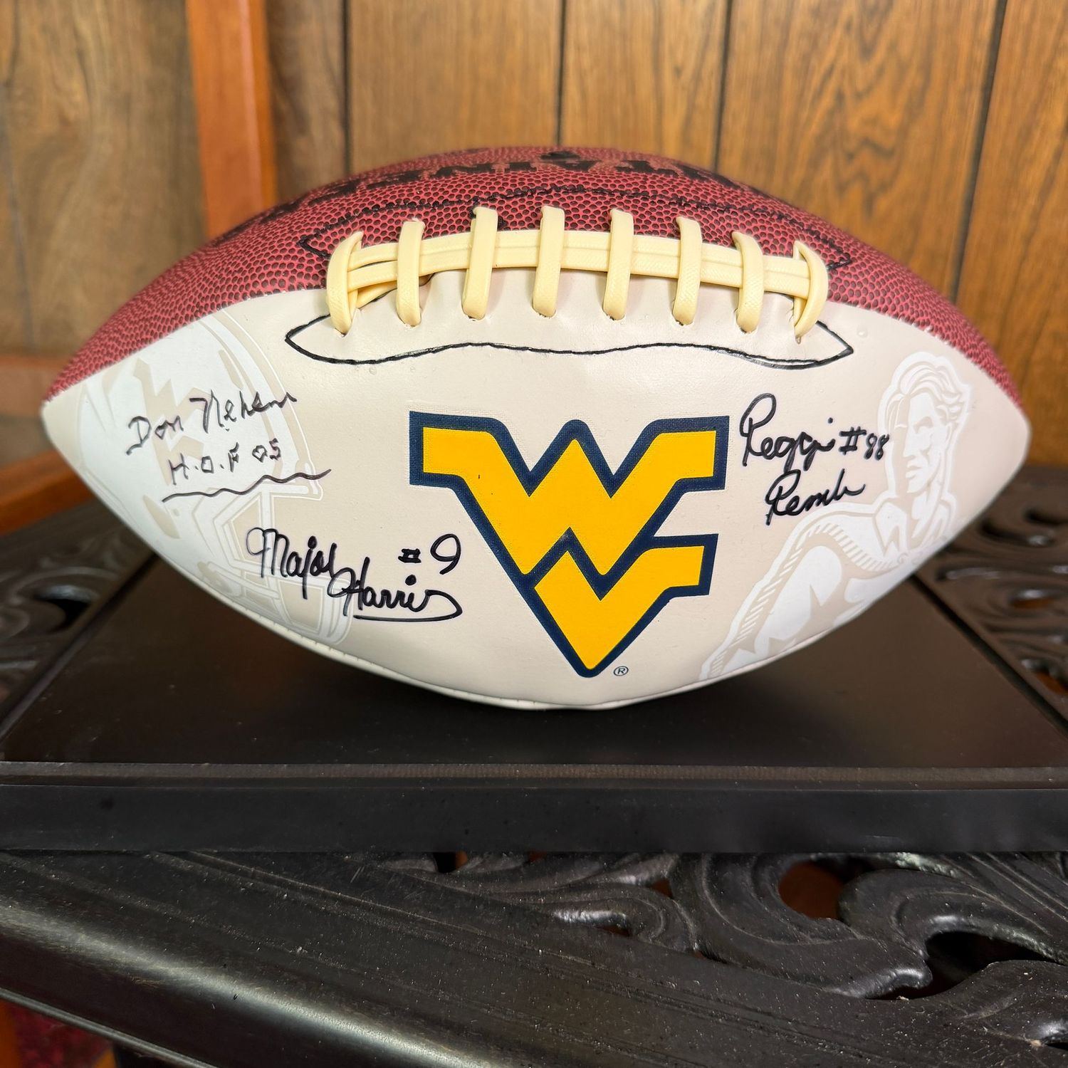 Football in case #8, WVU signed by Don Nehlen, Major Harris, and Reggie Rembert