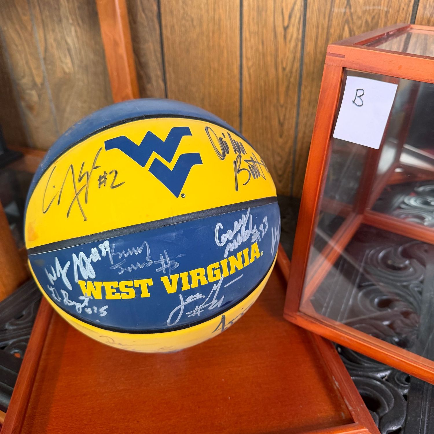 Autographed WVU Basketball in Case B, blue and gold, some haziness, Bob Huggins, Darryl Bryant, Da'Sean Butler, Ebanks, and more