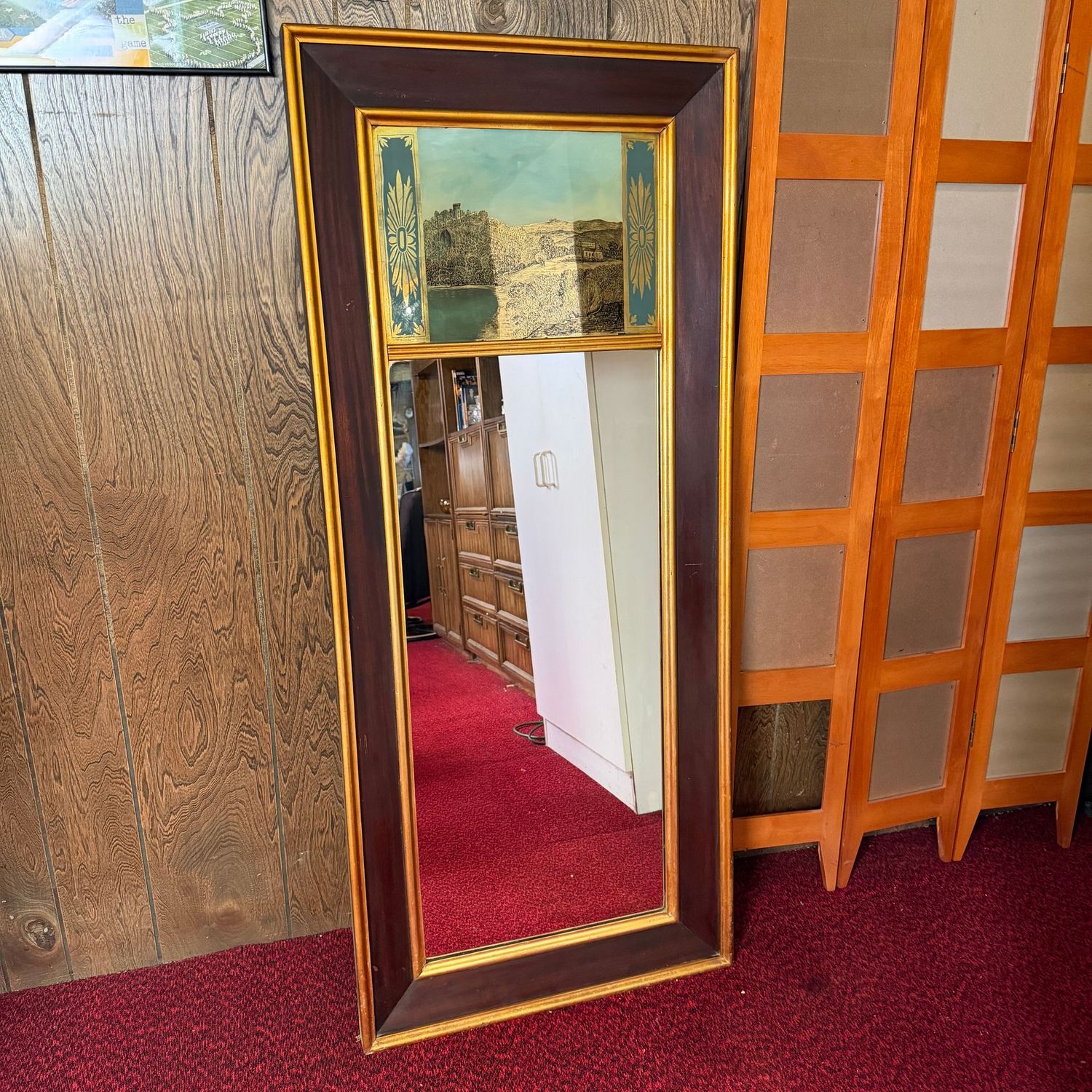 Tall rectangular mirror with wood frame (needs some wood polish), reverse-painted castle landscape above and gold borders throughout, 60"H x 27"W (This item is heavy and in the lower level)