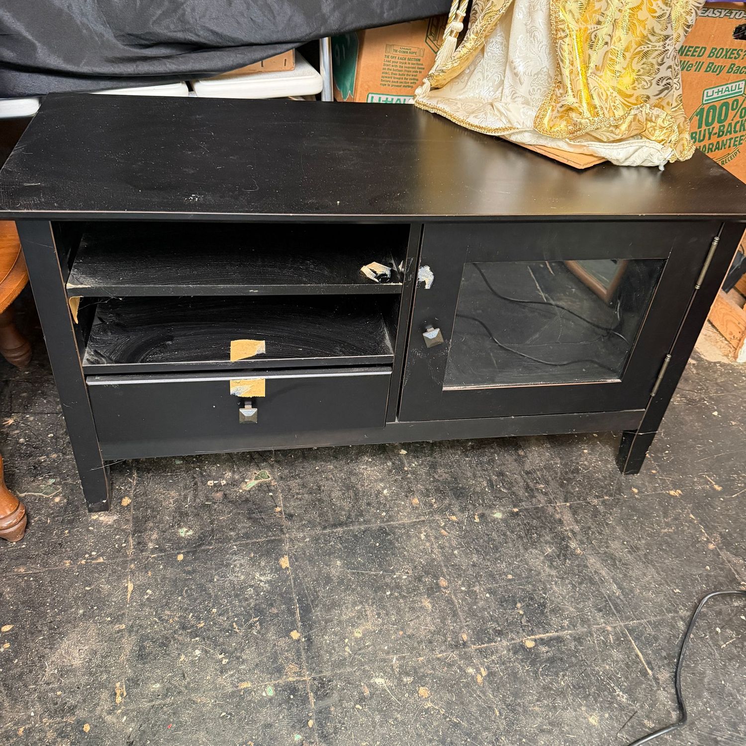 Black TV stand (in better condition than photographed), needs some tape removal, very sturdy and minimal scratches, 20"H x 39"L x 16"D (This item is heavy & in the lower level)