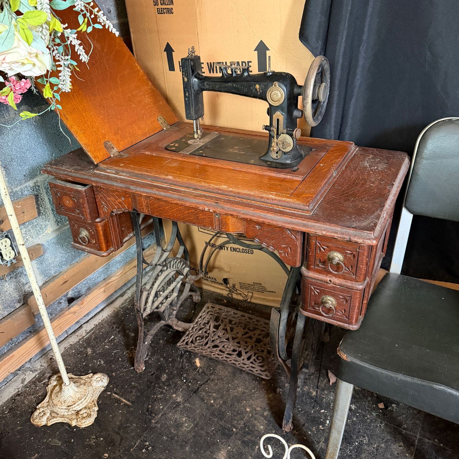 Montgomery Ward treadle sewing machine, great as-is or repurposed as the cast iron details are beautiful. 32"L (This item is heavy & in the lower level)