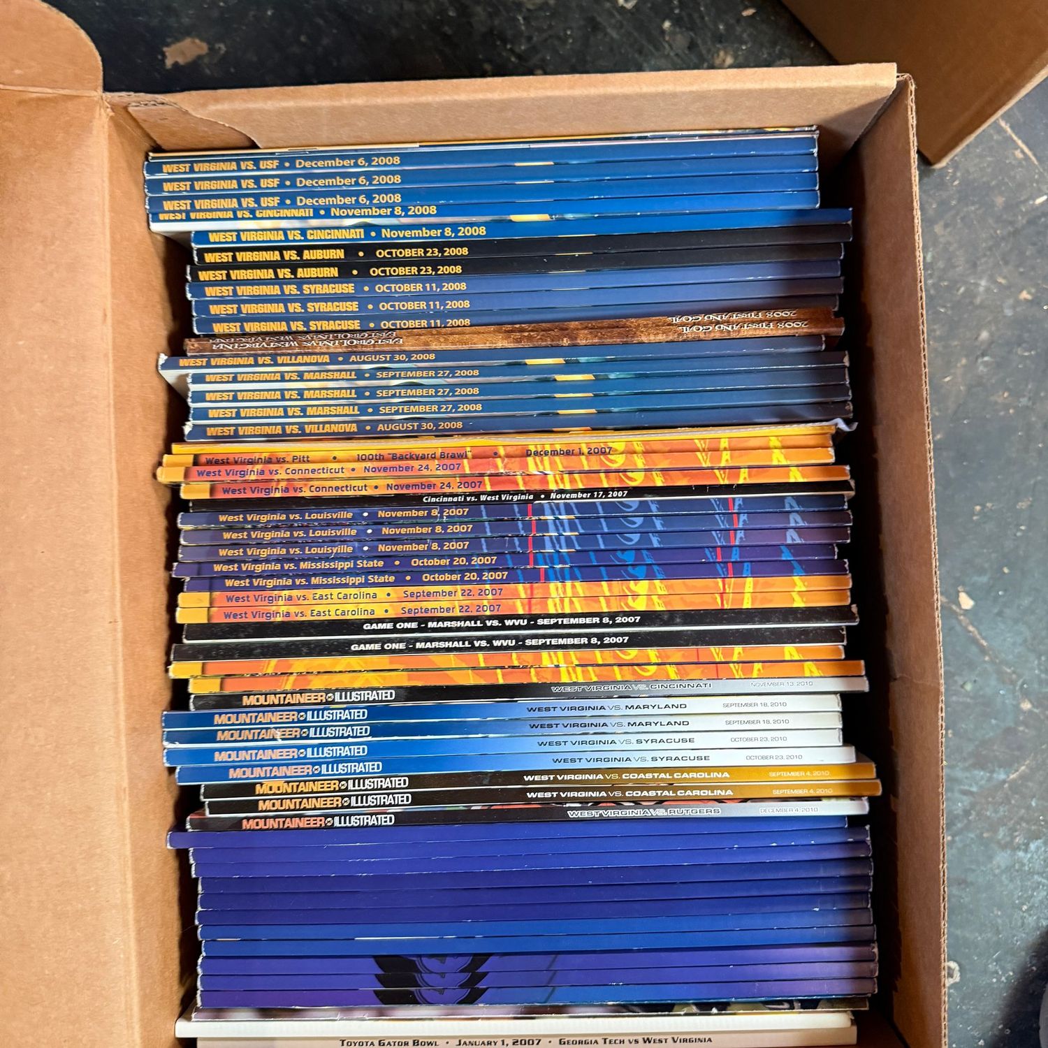 WVU/Sports Ephemera Box #12 Mountaineer Illustrated and guides from the mid 2000s (This item is heavy & in the lower level)