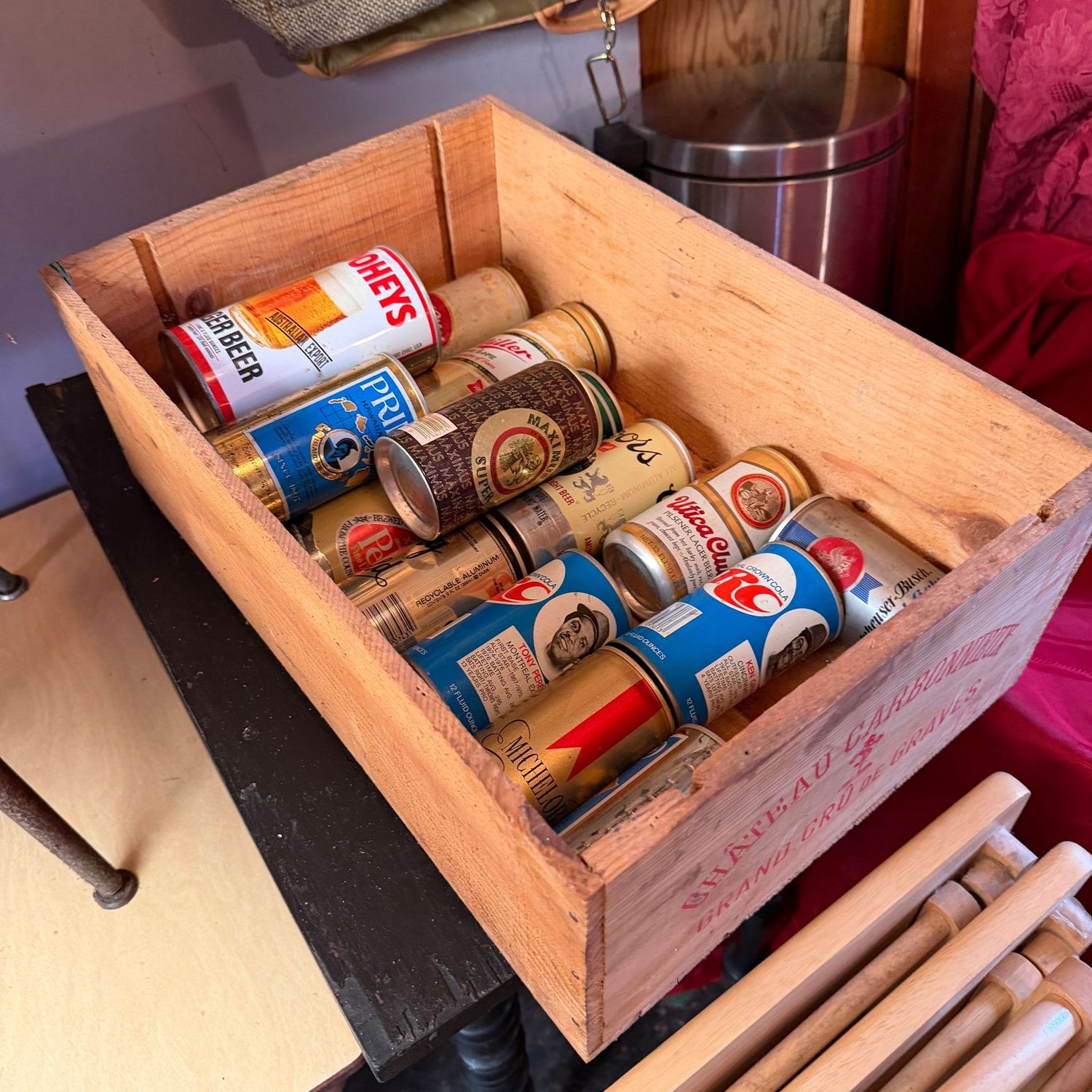 Wine crate filled with vintage beer cans