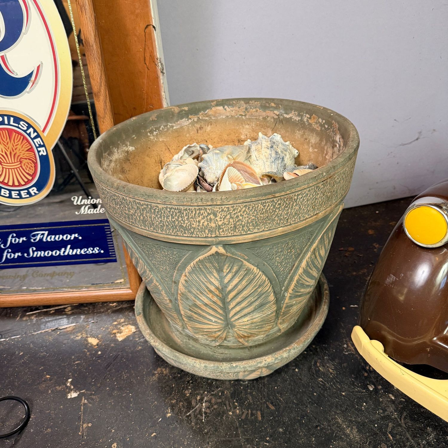 Large green terra cotta planter with base filled with sea shells 14"H x 16"W (This item is heavy & in the lower level)