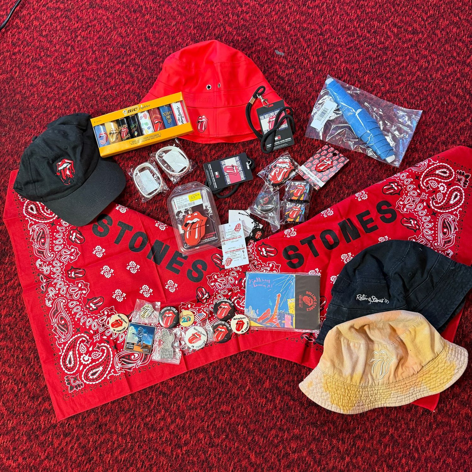 Rolling Stones memorabilia lot with bucket hats, bandanas, buttons, pins, lanyards, pennant