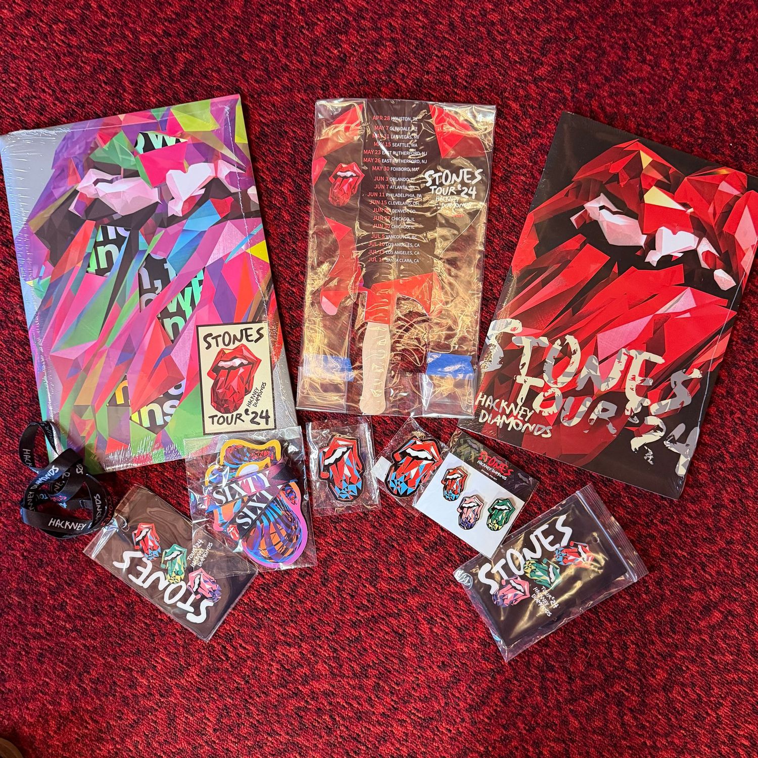 Rolling Stones memorabilia lot with a sealed program, fan, lanyards, and pins