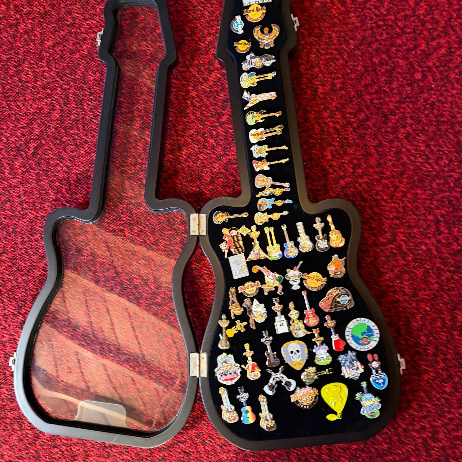 Large Hard Rock Cafe hard plastic guitar display case with dozens of hard rock pins, 30" x 13"