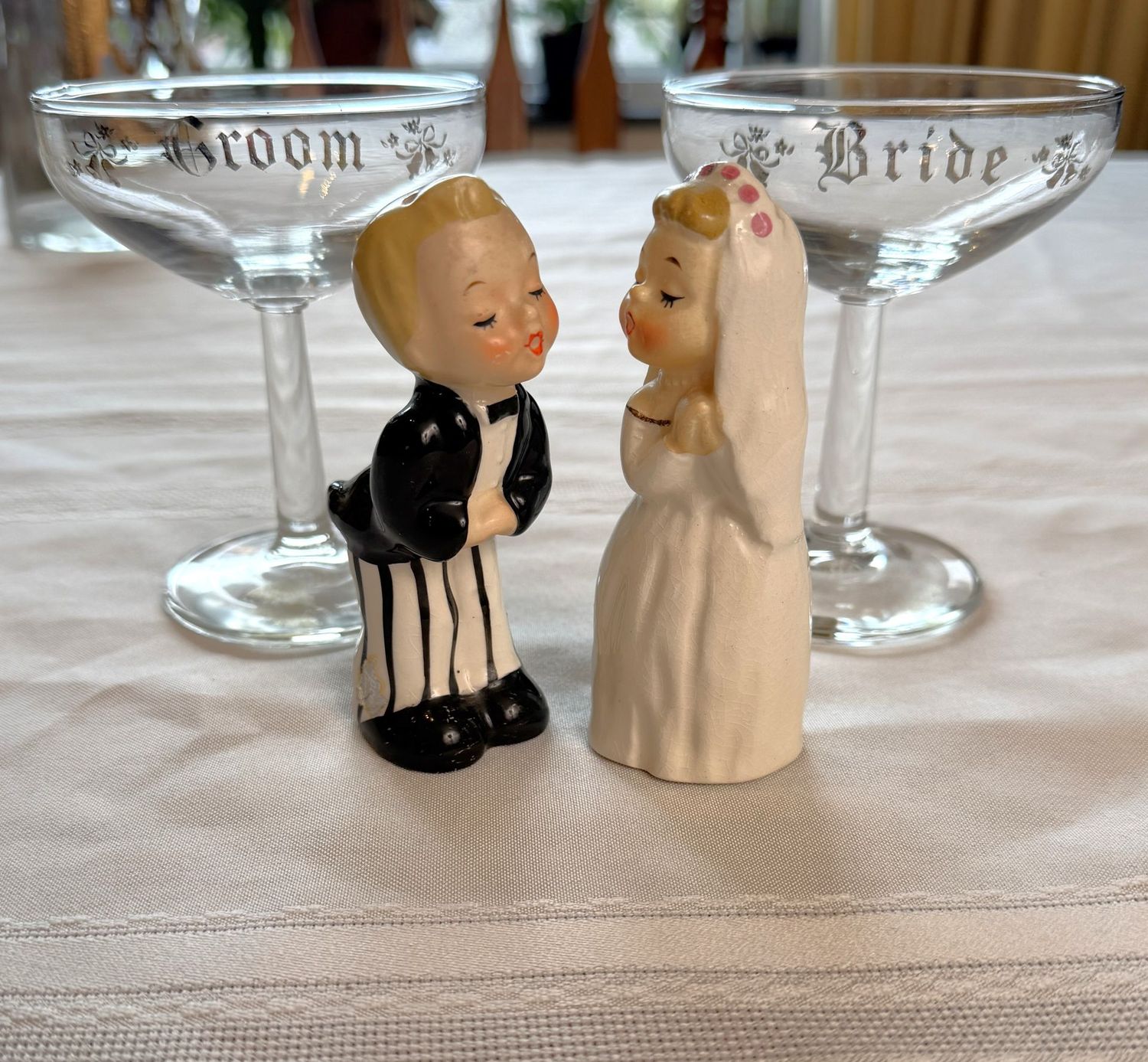Bride and Groom champagne toasting glasses and kissing bride and groom salt & pepper shakers