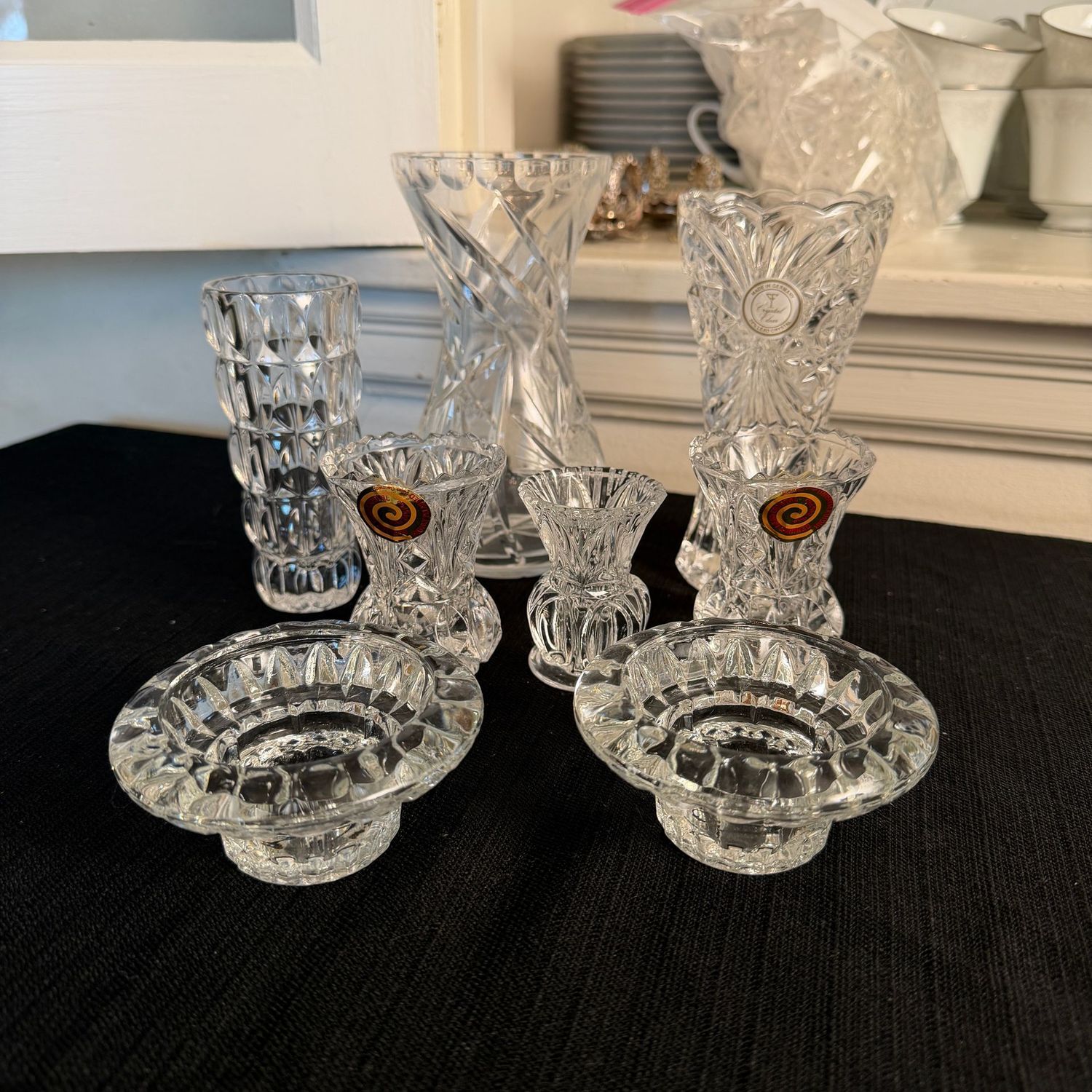 Grouping of lead crystal candle holders, toothpick holders and small vases, the tallest is 7"