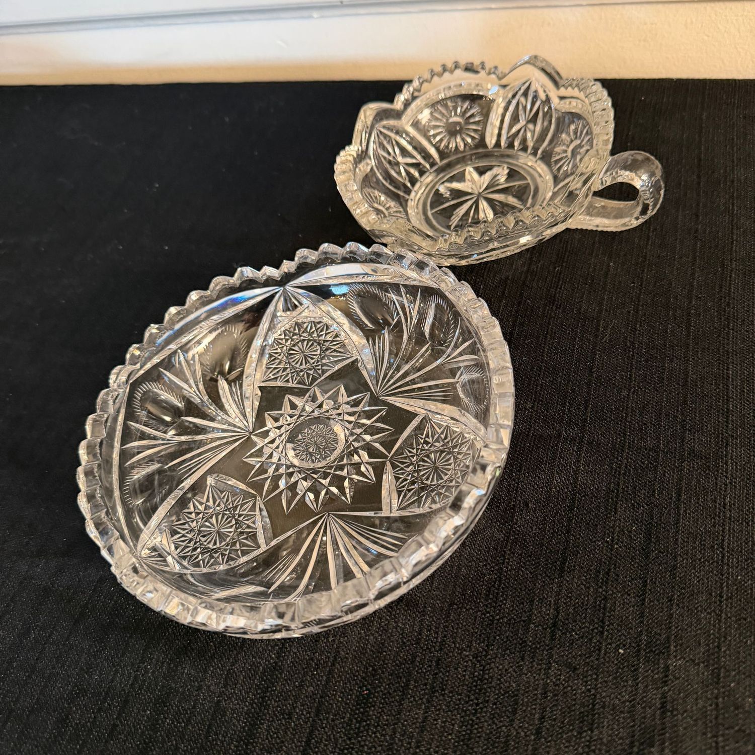Clear crystal nappy and bowl with sawtooth edges, the largest is 7.5"W