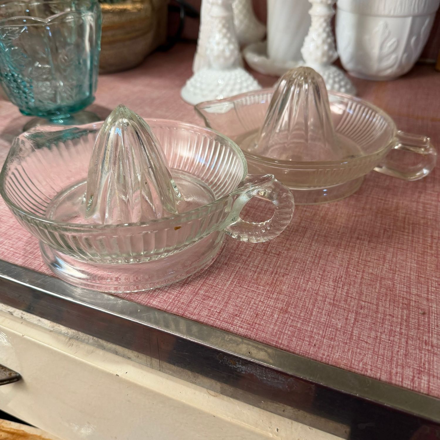 Two clear glass juicers
