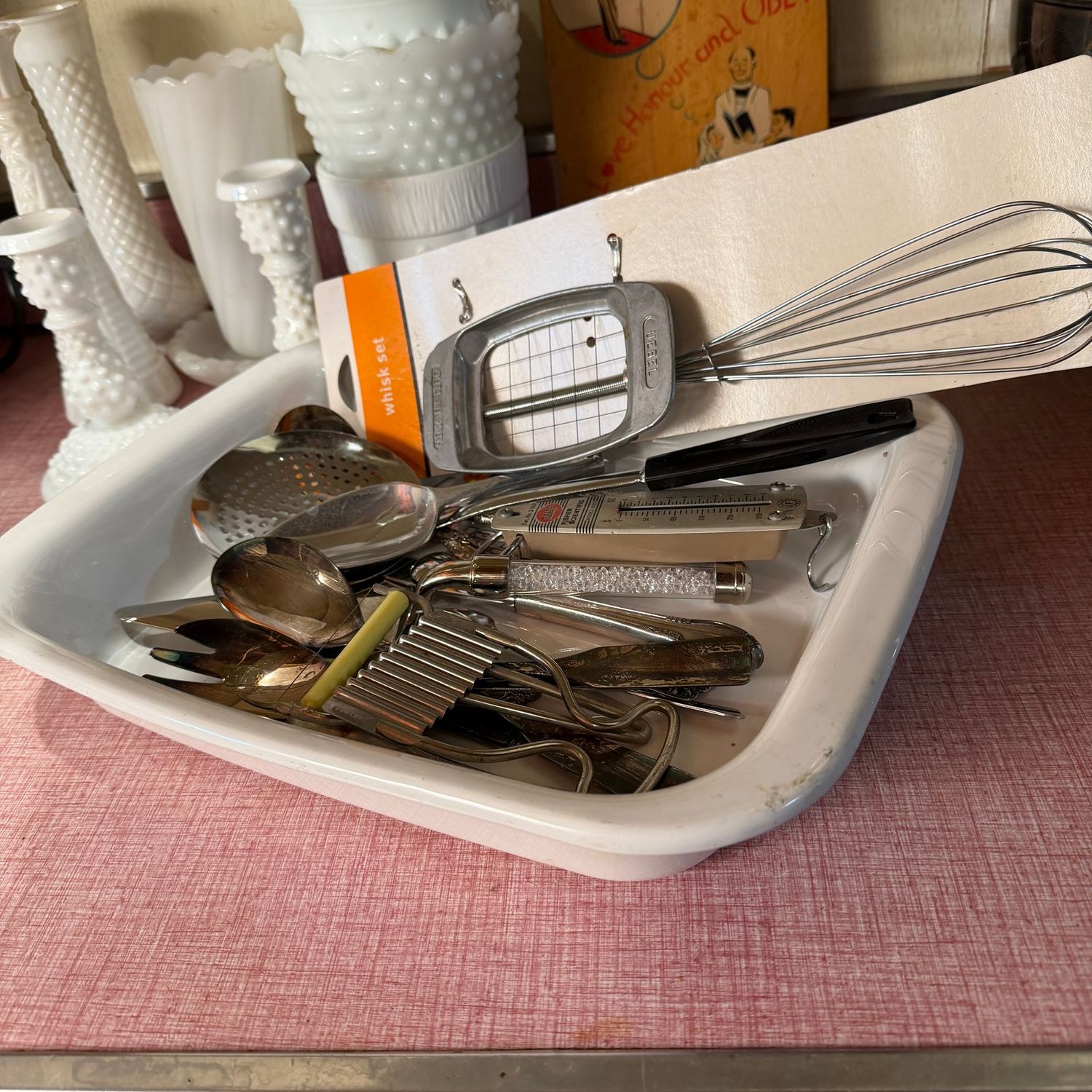 White casserole pan with group of kitchen utensils, pan is 12" x 9"
