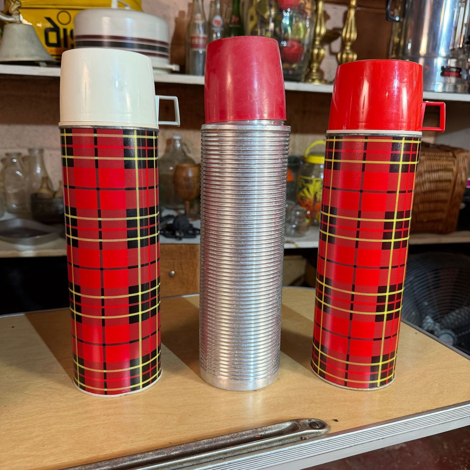 Three vintage metal Thermos, full-size