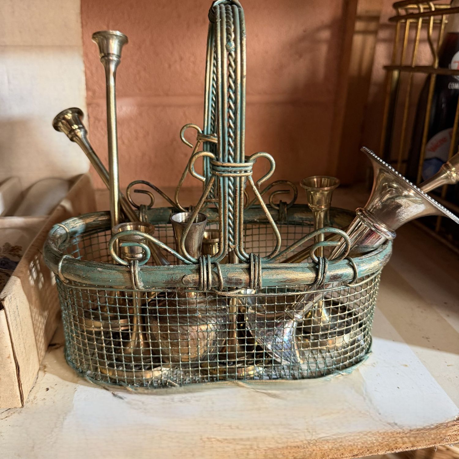 Mesh metal basket of mostly brass candle holders, 2-6"