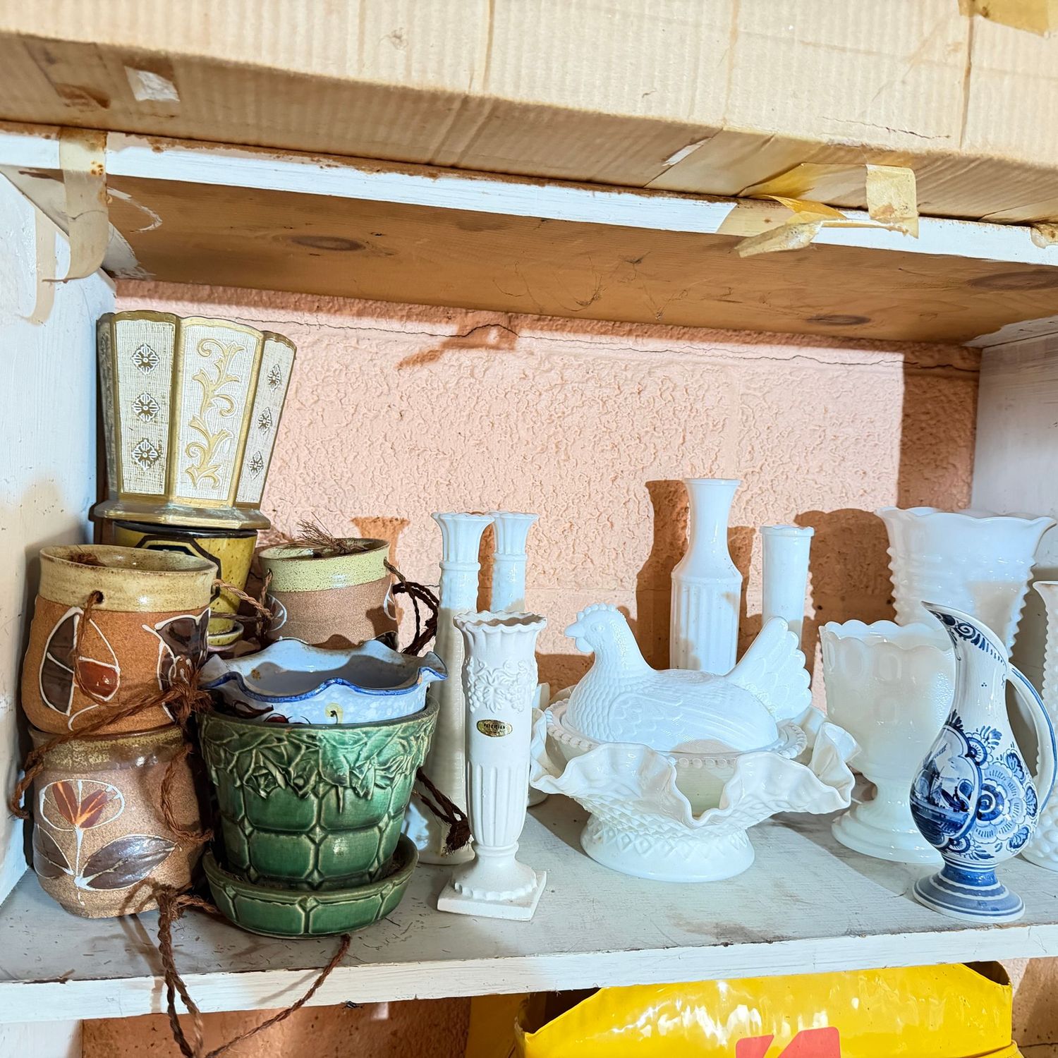 Shelf with vintage planters and milk glass vases