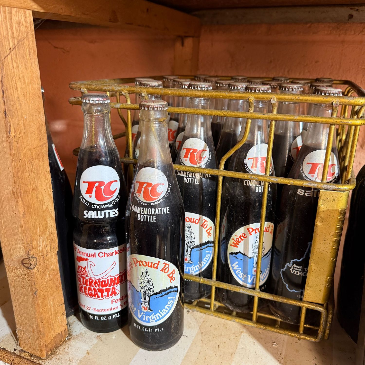 Metal milk crate filled with RC filled cola bottles, most are WV