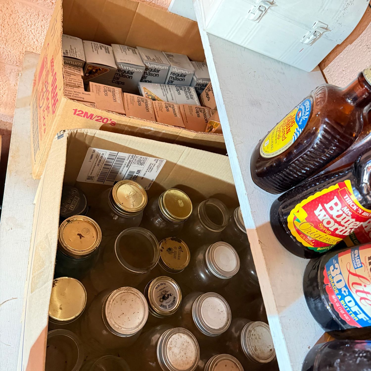 Two large boxes filled with canning jars and unopened jar caps and lids (This item is heavy & in the Lower Level)