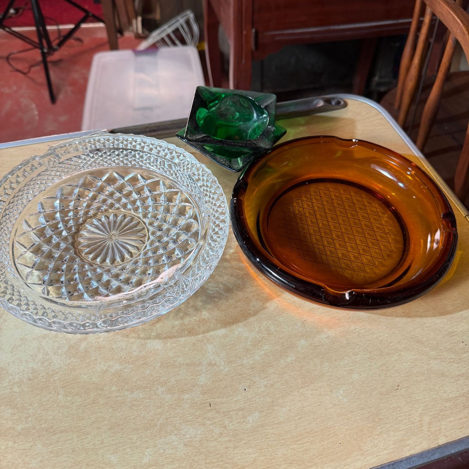 Grouping of clear, amber, and emerald vintage ashtrays