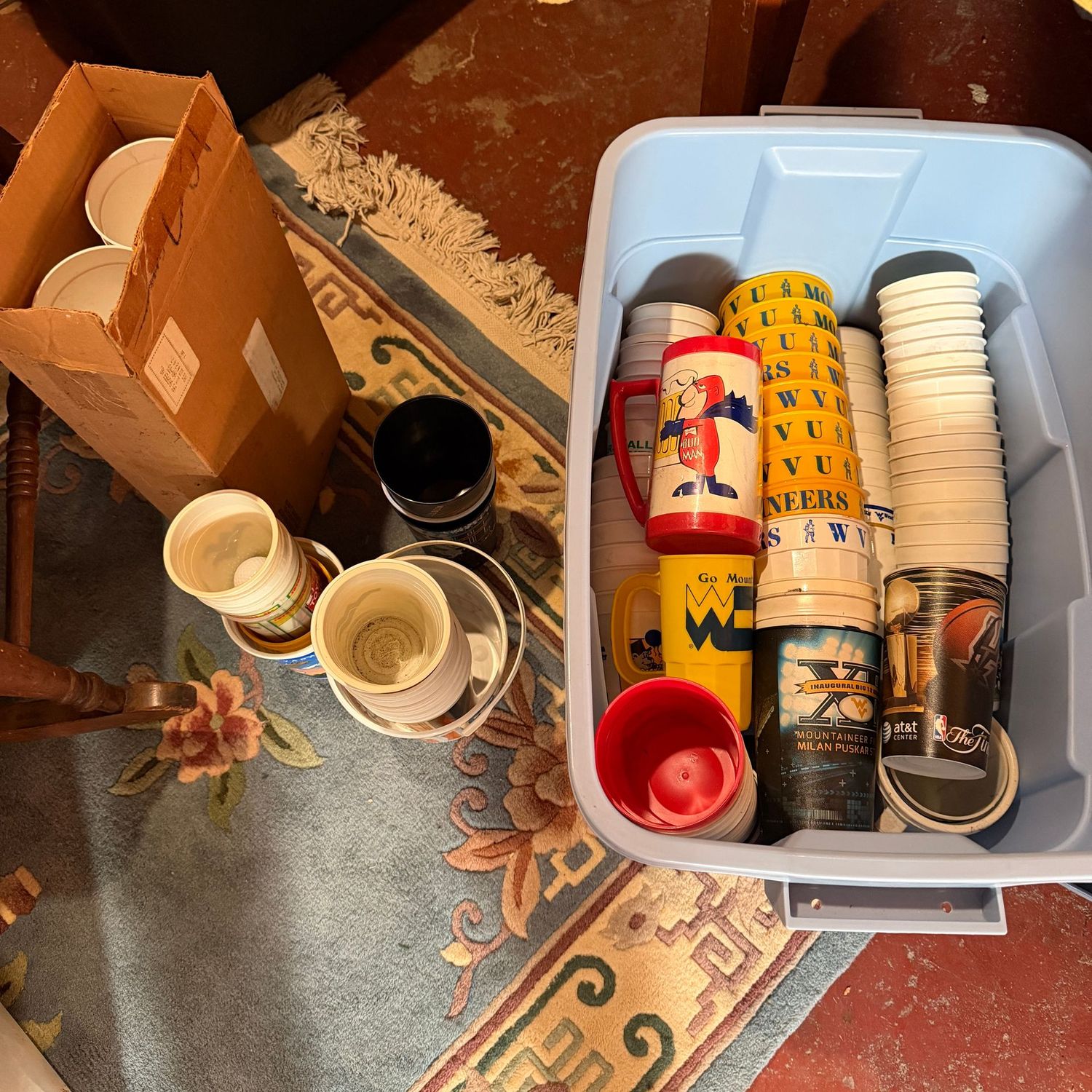 Mystery bin with lid of mostly WVU plastic drink cups