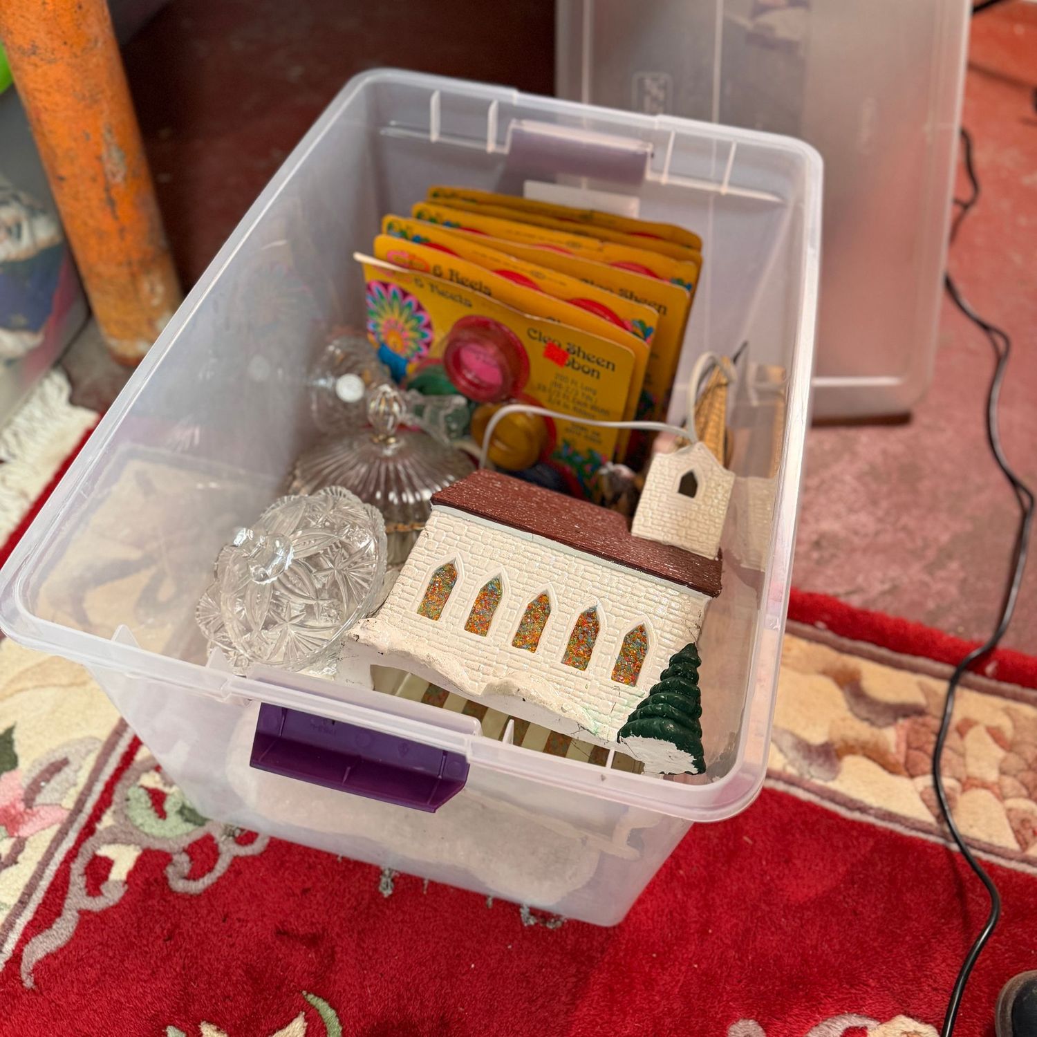 Clear bin with lid of ceramic church, glass candy dishes, vintage curling ribbon
