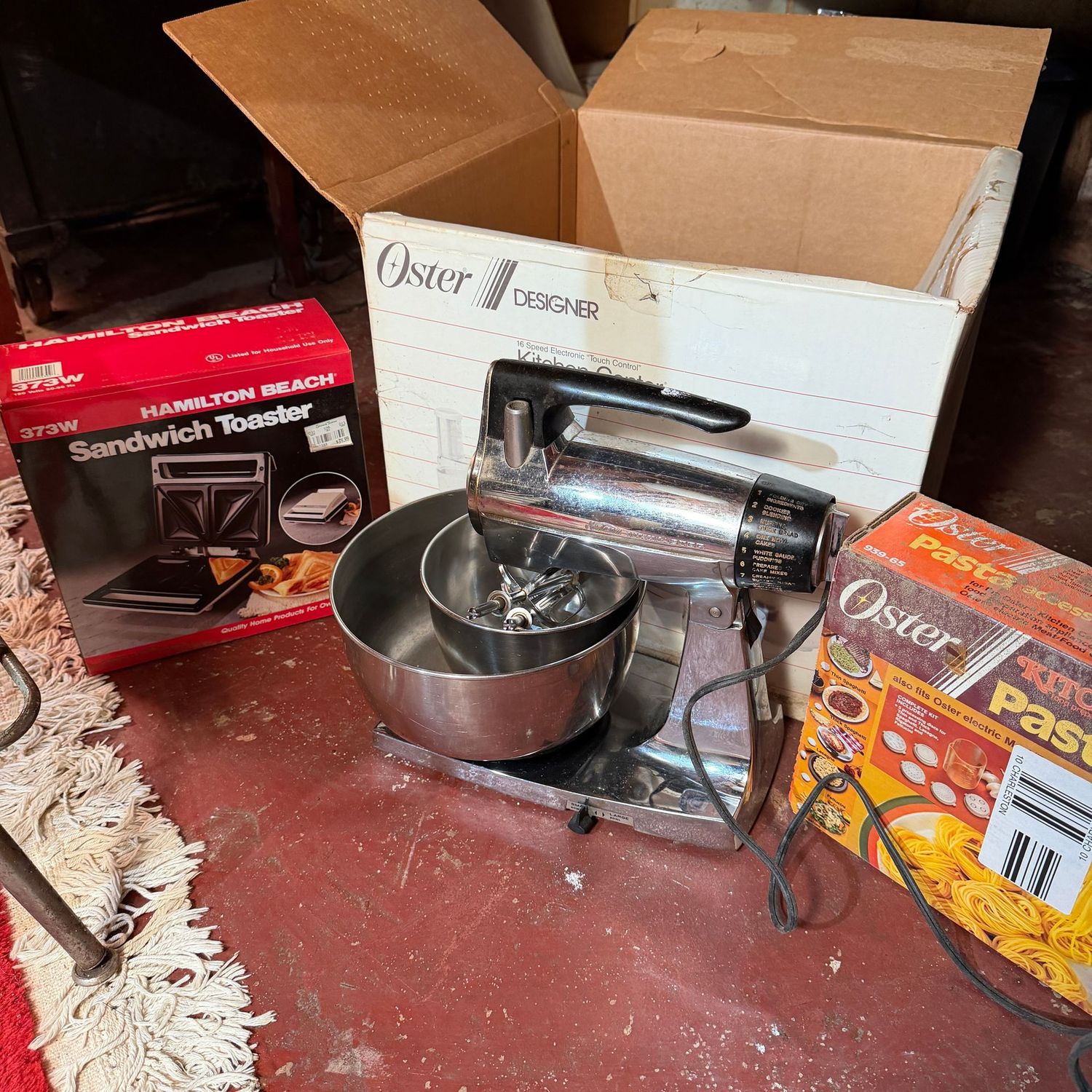 Lot of kitchen items with vintage mixer (works on test) pasta center from Oster, and unopened box with sandwich toaster