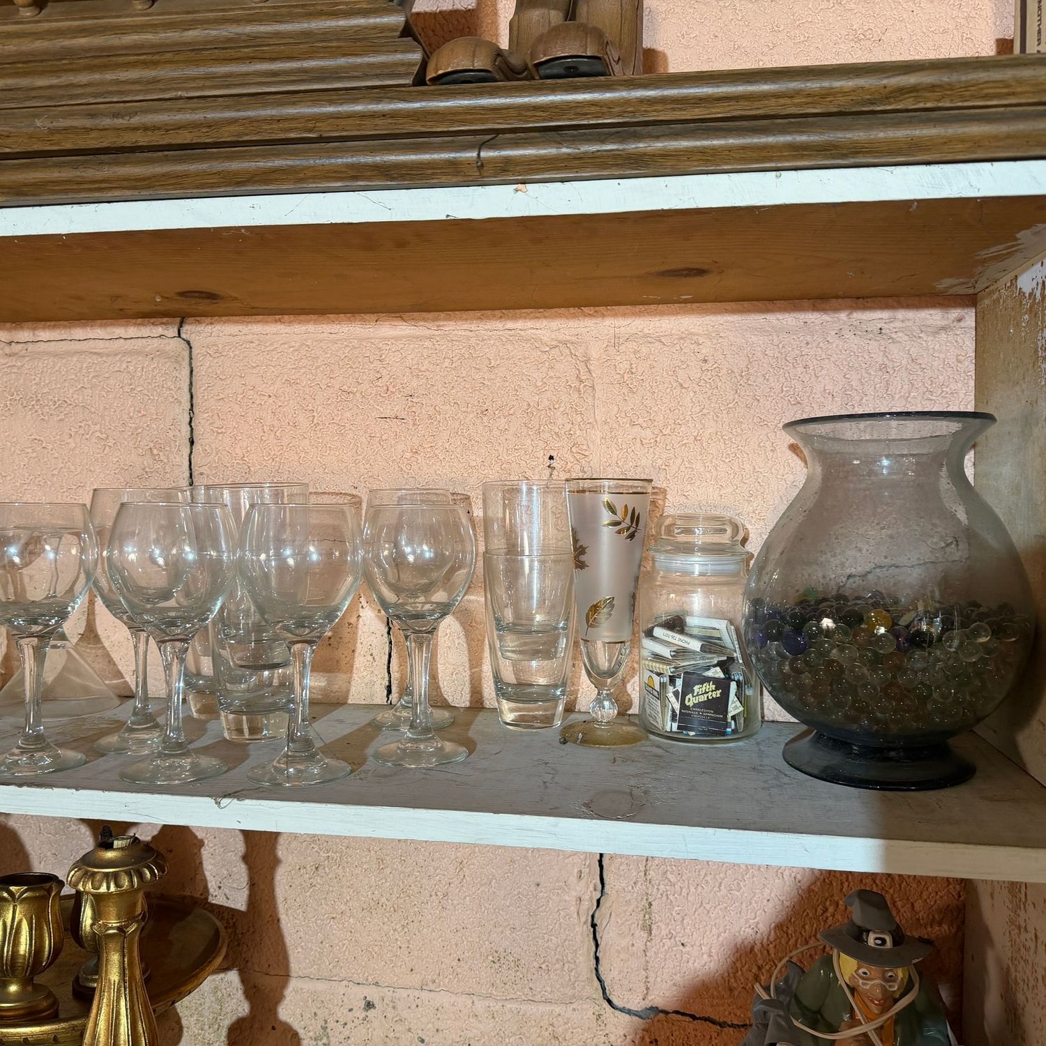 Shelf filled with stemware, vase with decorative marble glass