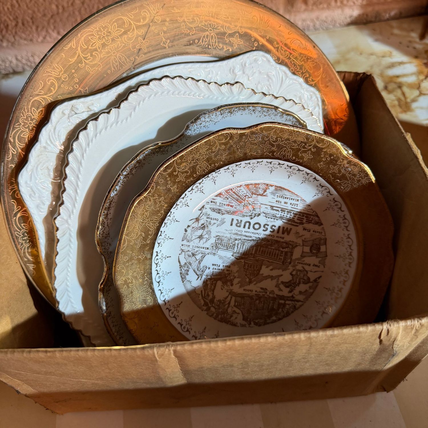 Small group of gold-decorated plates, including one of Queen Elizabeth