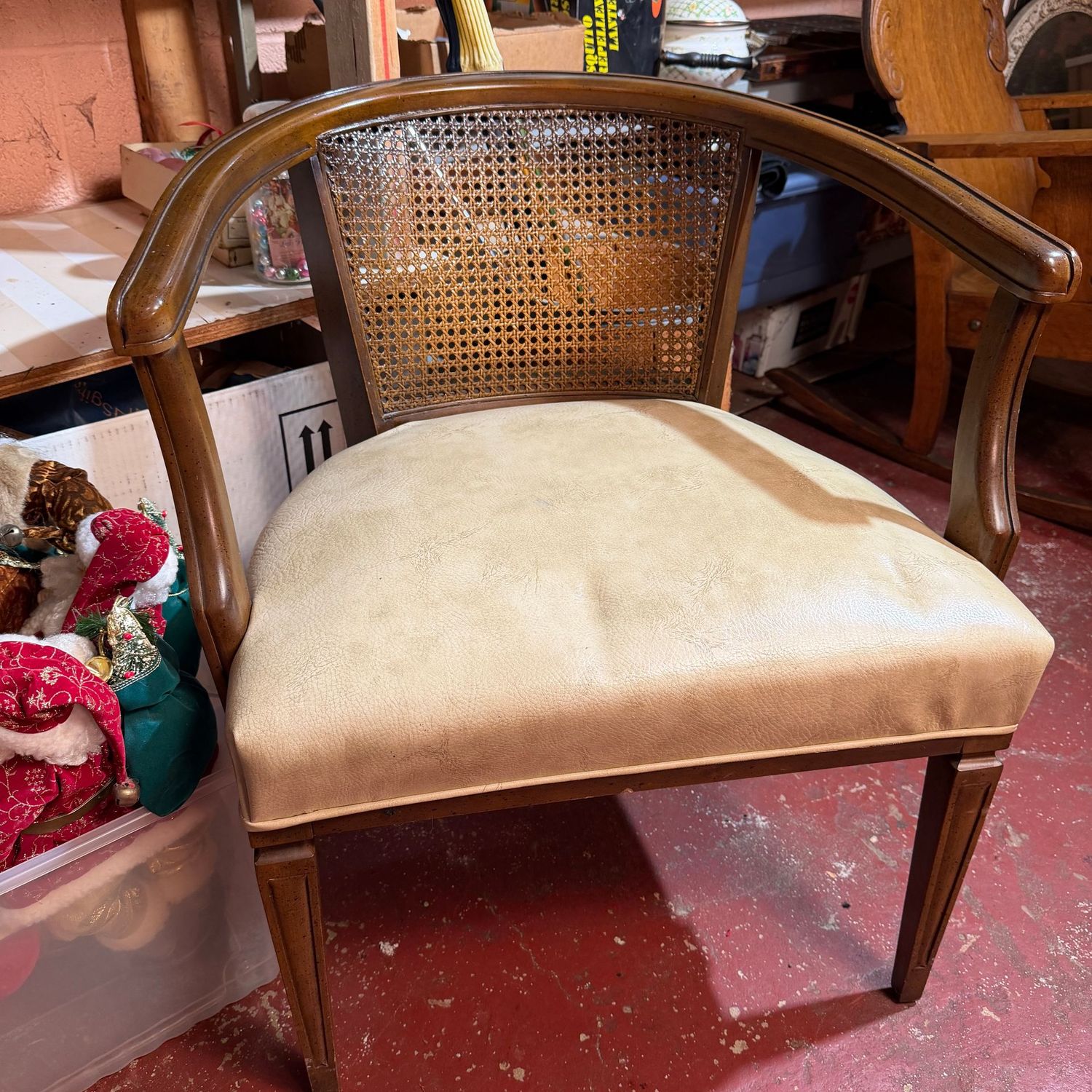 Vintage wooden armchair with cane back, vinyl seat, some wear, 30"H x 26"D (This item is heavy & in the Lower Level)