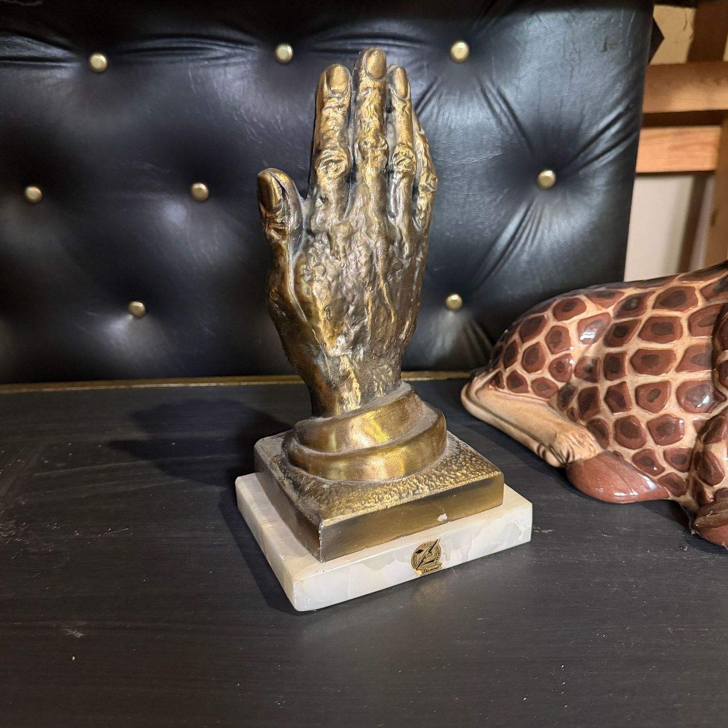 Large cast metal hand bookend on onyx, 9"