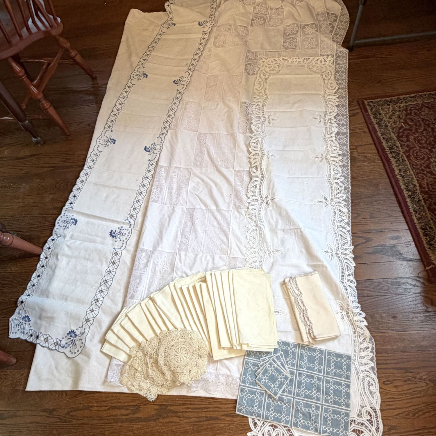 Group of ivory and blue napkins, table runners, doilies, and tablecloths, most will fit a 6ft. long rectangular table, some spots