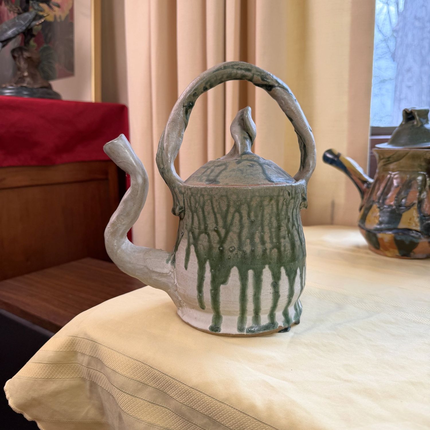 Pottery teapot with green drip glaze, lid is sealed shut, Laura Sibley, 10"H x 8"W