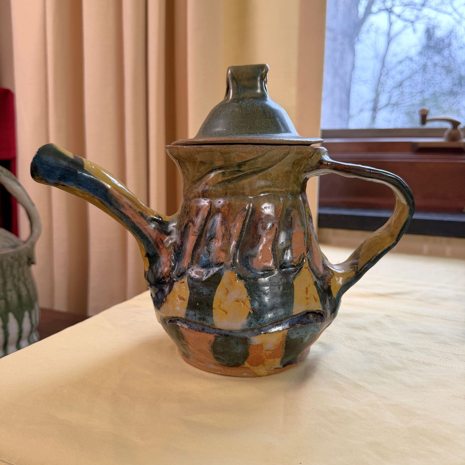 Multi-color glaze pottery teapot, Laura Sibley, 9 Multi-color glaze pottery teapot, Laura Sibley, 9"H x 10"W