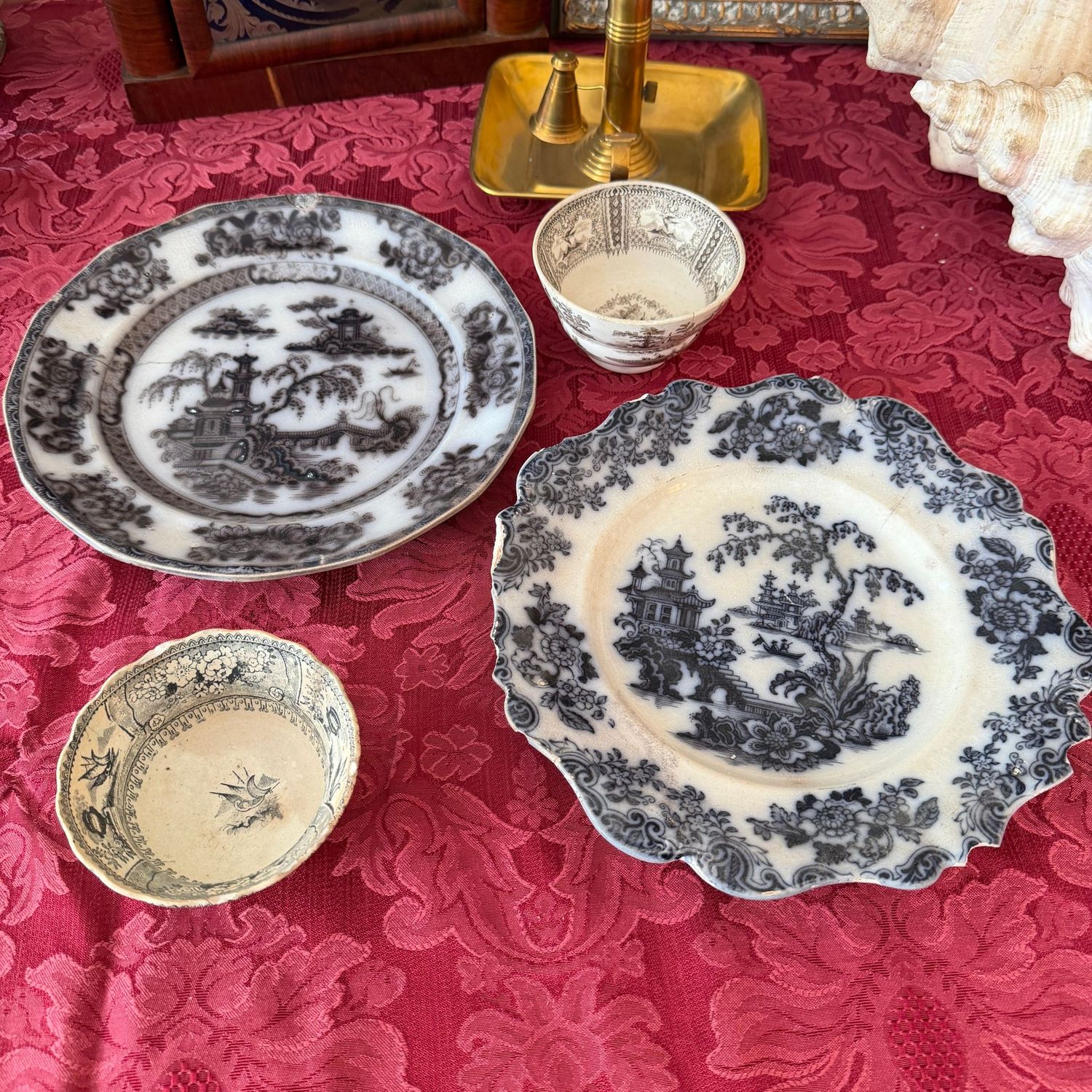 Grouping of ironstone, black and white transferware cups and dinner plates, some wear and hairline cracks to all