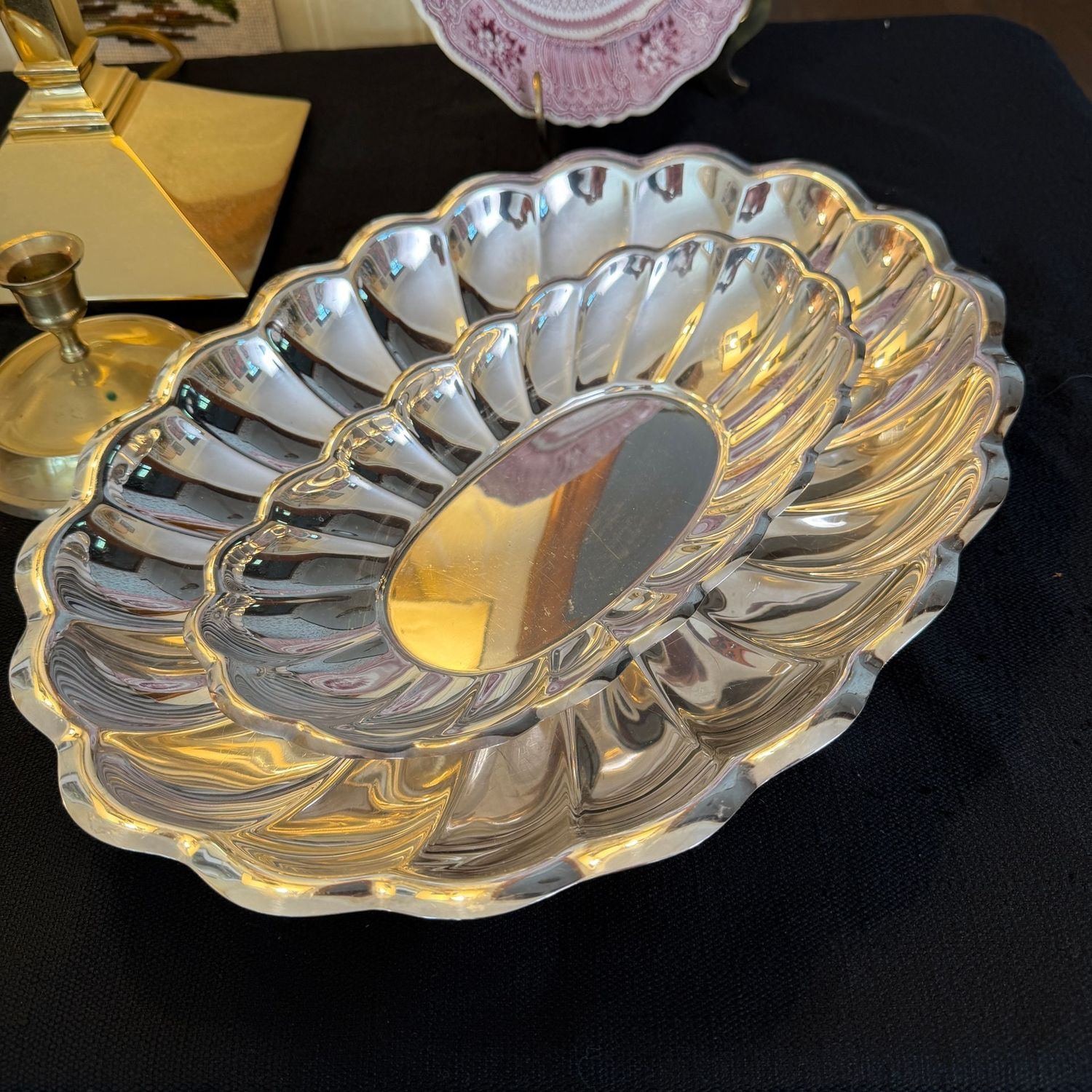 Two silver-plated oval dishes with scalloped edges, the largest is 14" x 10"